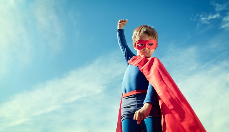 Child in a mask and cape